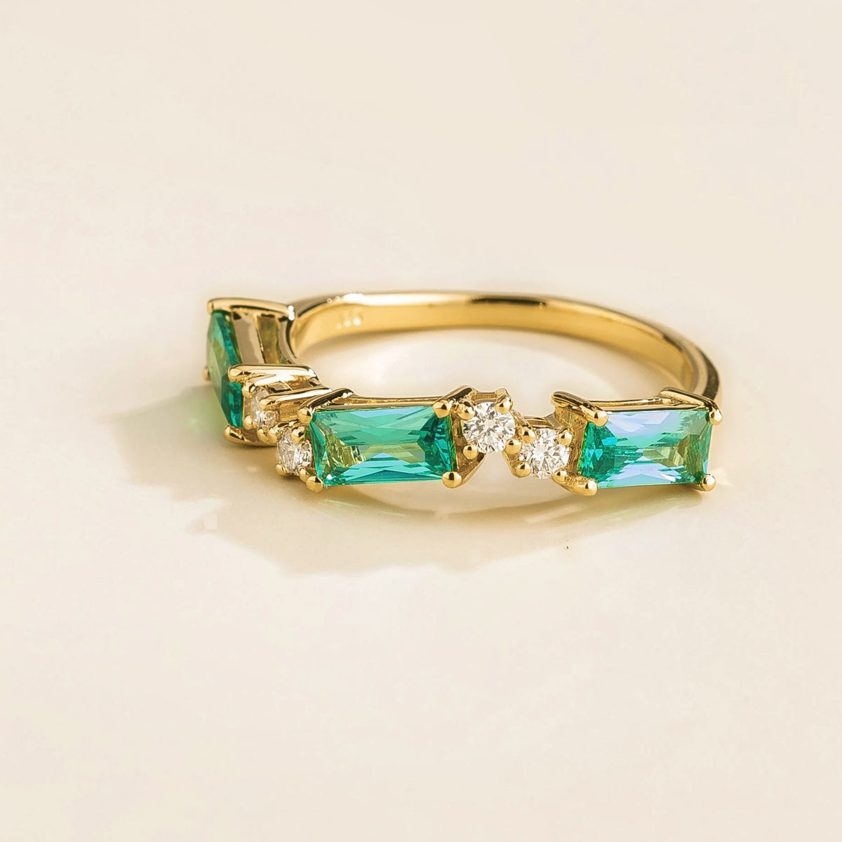 Forma Paraiba & Diamond Baguette Cut Three-Stone Ring in Gold – angle view