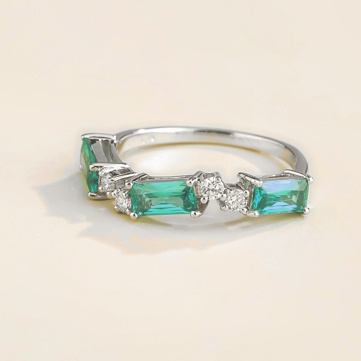 Forma Paraiba & Diamond Baguette Cut Three-Stone Ring in White Gold – angle view