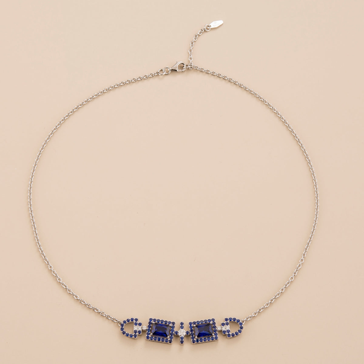 Ciceris pastel blue sapphire Art Deco halo necklace in white gold, two emerald-cut lab-grown sapphires with diamonds, front view | Juvetti London