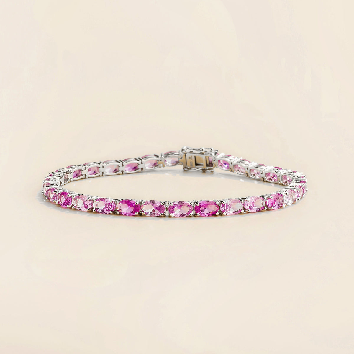 Salto pastel pink sapphire oval tennis bracelet in white gold