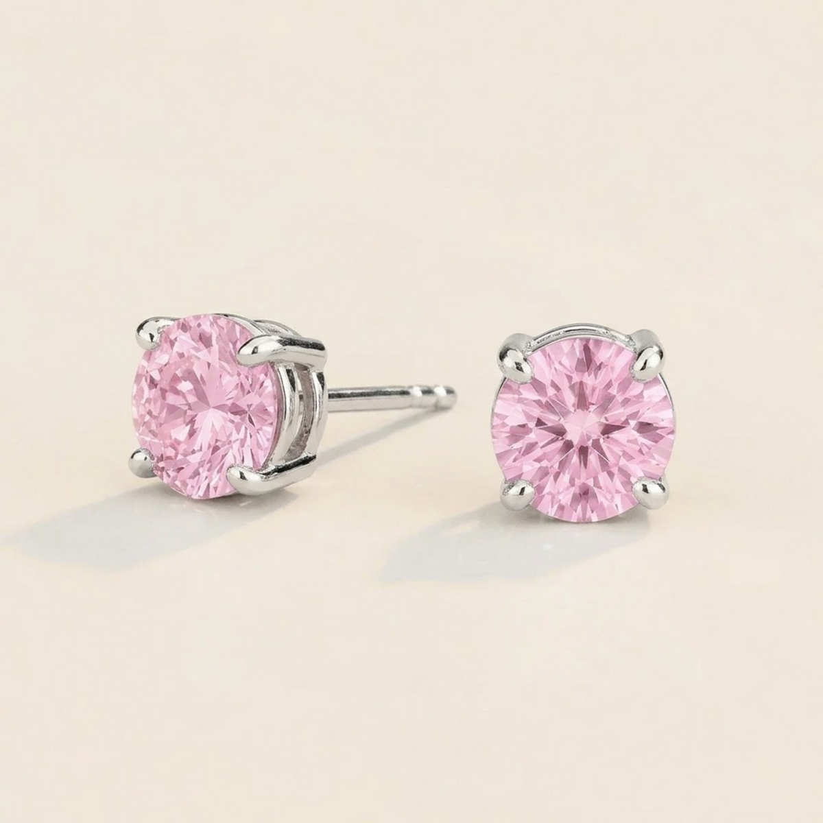 Nina round lab-grown pastel pink sapphire solitaire stud earrings in white gold – angled view | Juvetti London