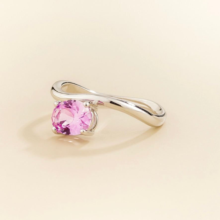 Luno pastel pink sapphire oval ring in white gold, lab-grown sapphire set east-west, angled view | Juvetti London