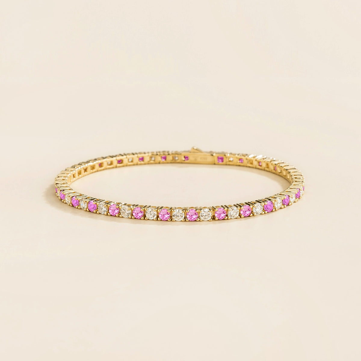 Round lab-grown pink sapphire and diamond tennis bracelet in gold | Juvetti London