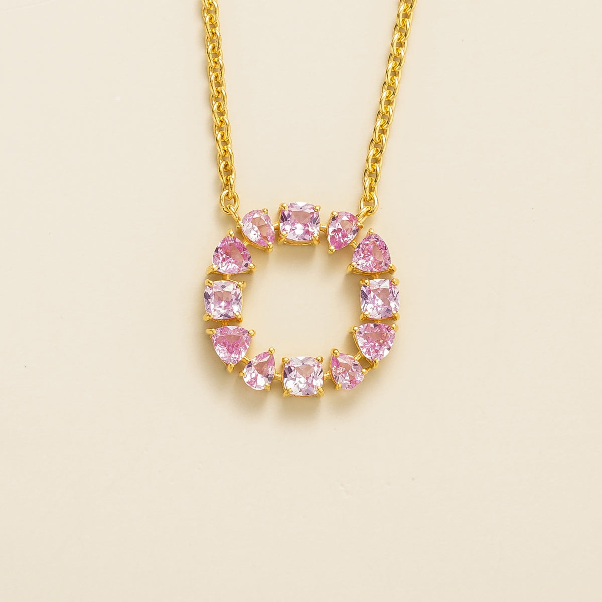 Glorie pink sapphire open circle pendant necklace in gold, mixed-cut lab-grown sapphires, front view | Juvetti London