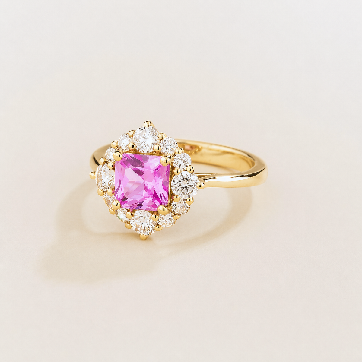 Tuli cushion-cut lab-grown pink sapphire and diamond halo ring in gold – angle view | Juvetti London