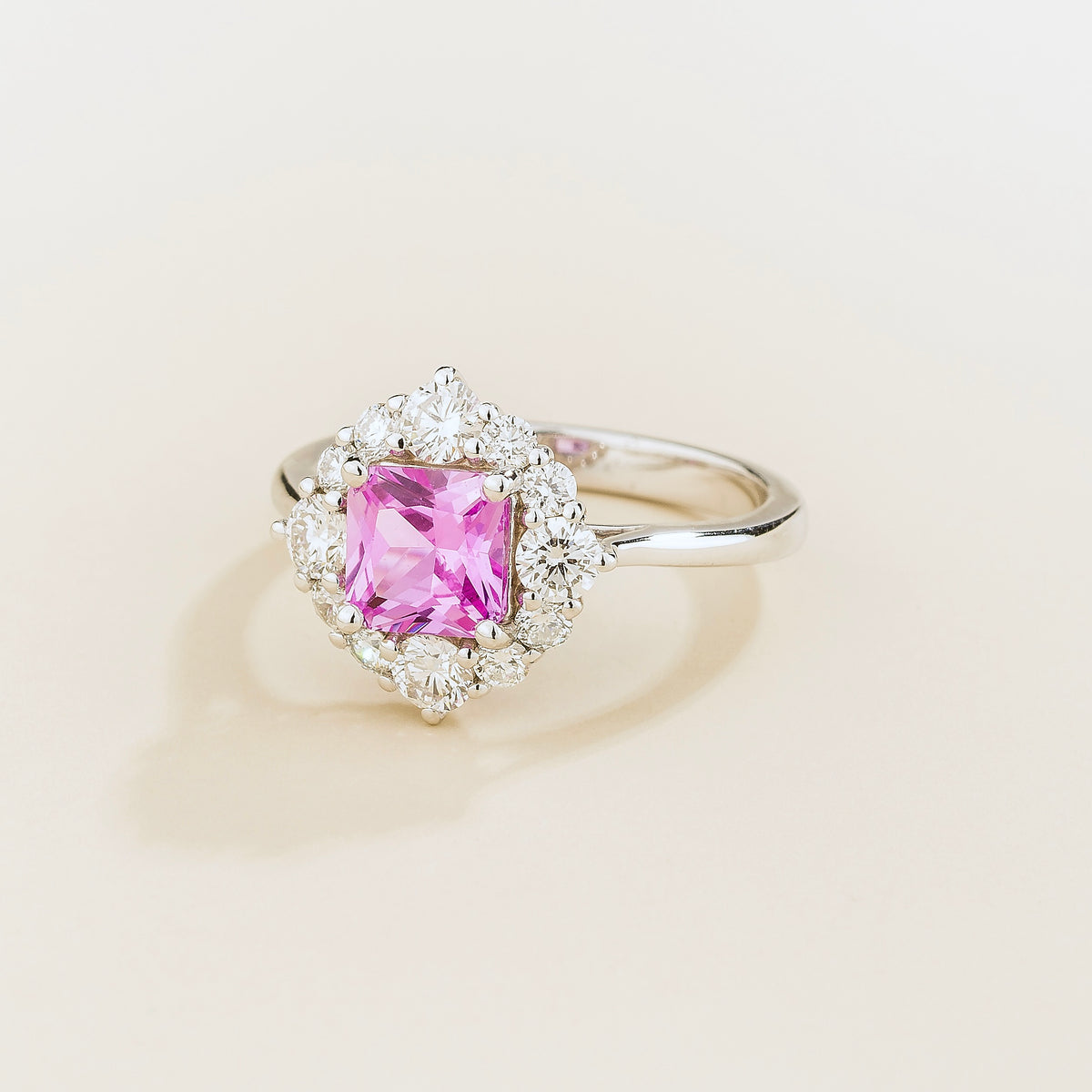 Tuli cushion-cut lab-grown pink sapphire and diamond halo ring in white gold – angle view | Juvetti London