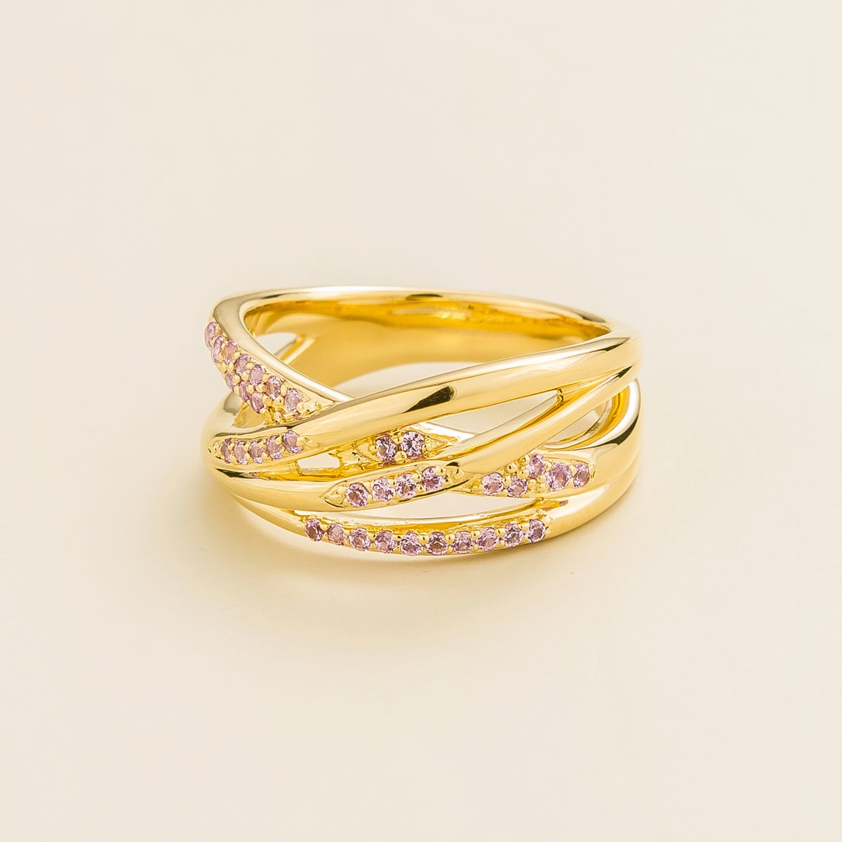 Val multi-row crossover band ring with lab-grown pink sapphires in gold – angle view | Juvetti London
