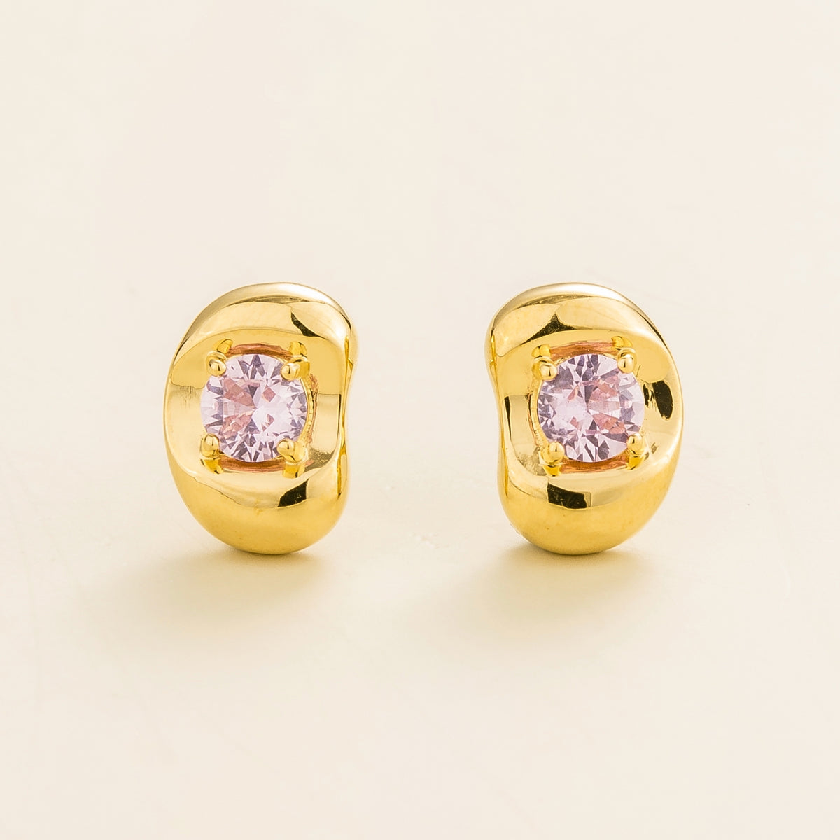 Fava round lab-grown pink sapphire stud earrings in gold, sculpted pebble setting, front view | Juvetti London