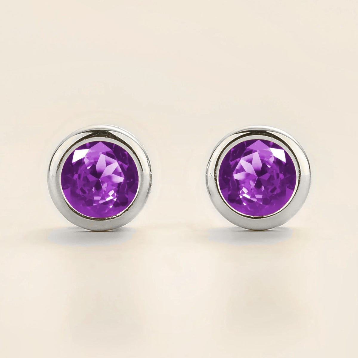 Margo purple sapphire round bezel set solitaire stud earrings in white gold