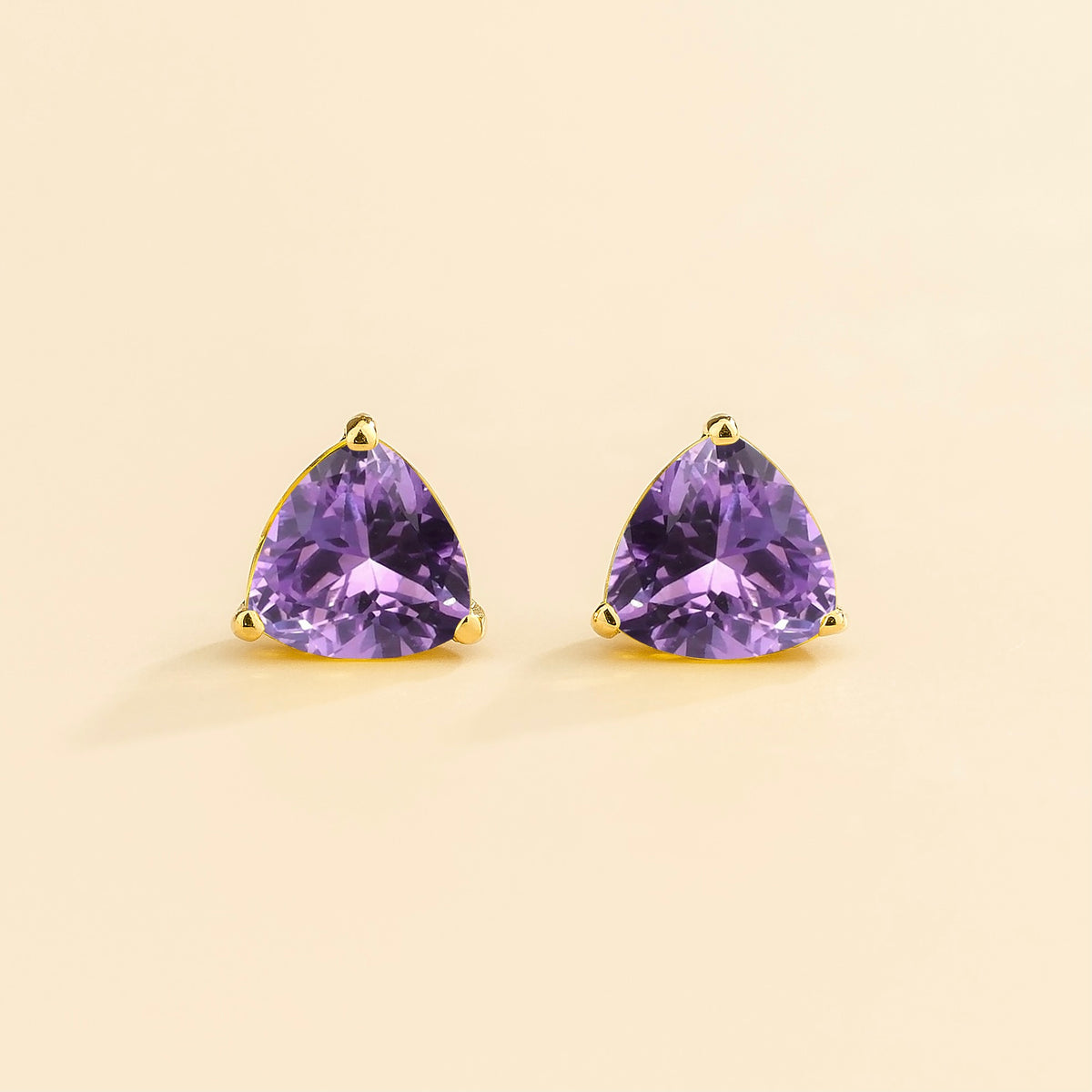Trillion purple sapphire solitaire stud earrings in gold