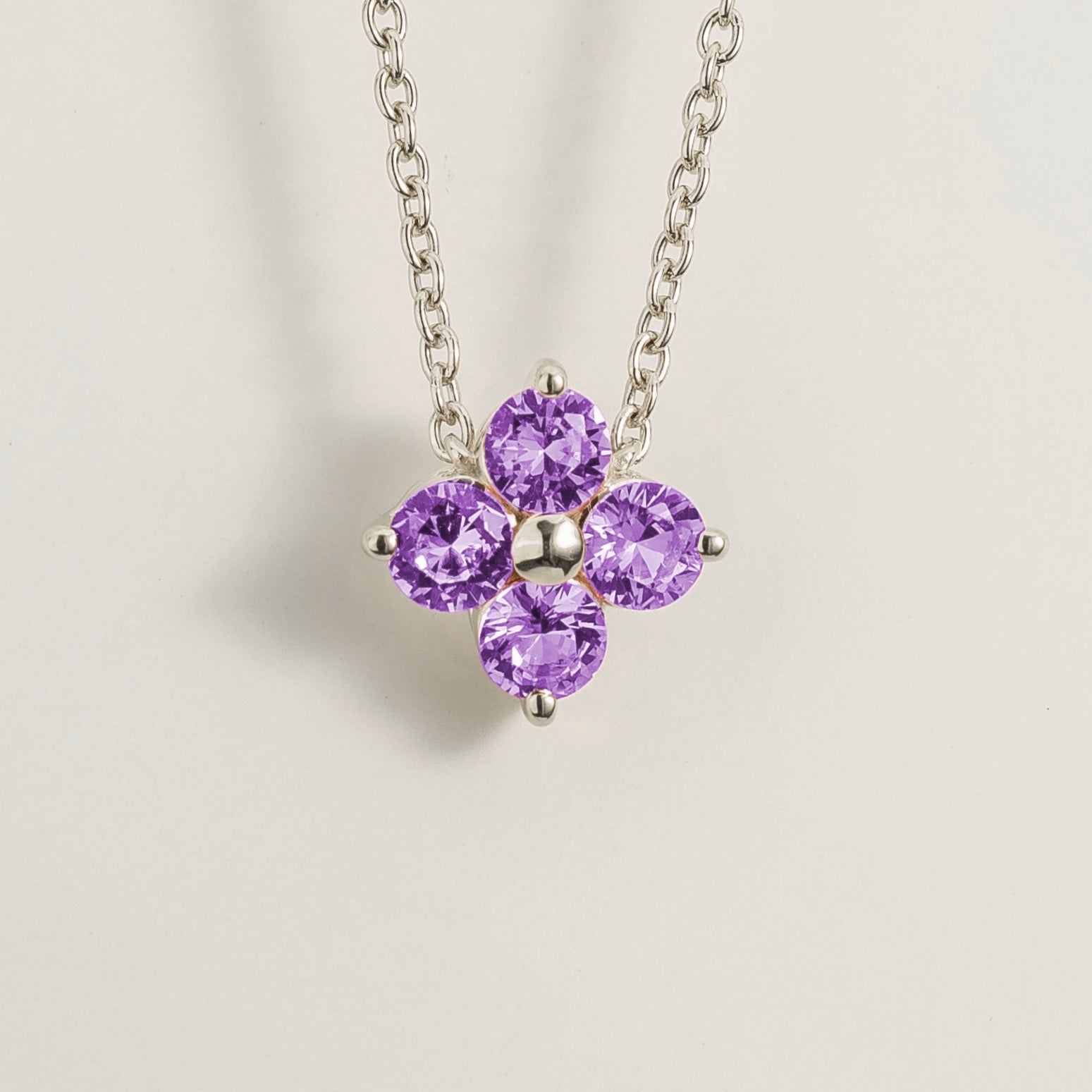 Front view of the Clover Purple Sapphire Necklace In White Gold, handcrafted by Juvetti London