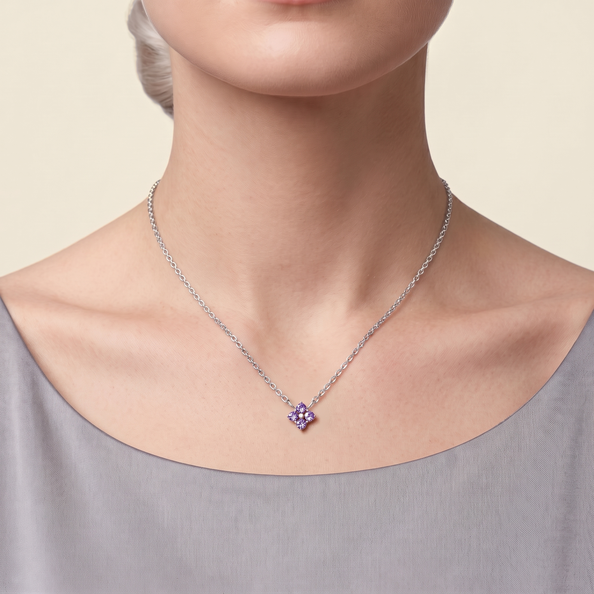 Clover purple sapphire necklace in white gold worn by a model, Juvetti London