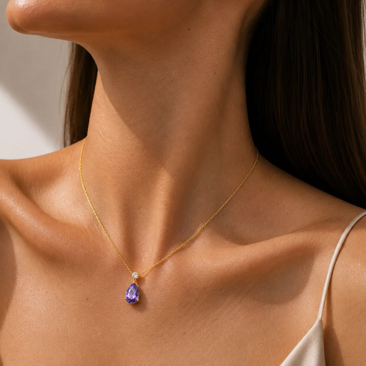 Model wearing a lab-grown purple sapphire and diamond pear drop pendant necklace in gold, large | Pisa by Juvetti