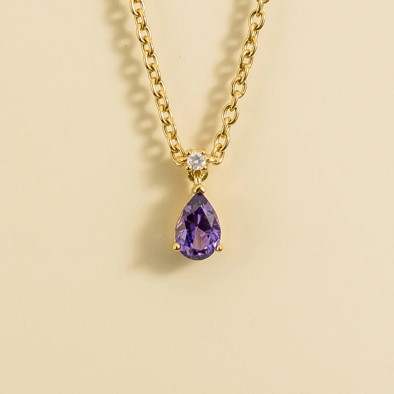 Front view of the Pisa Purple Sapphire & Diamond Pear Drop Pendant Necklace In Gold - Small, handcrafted by Juvetti London
