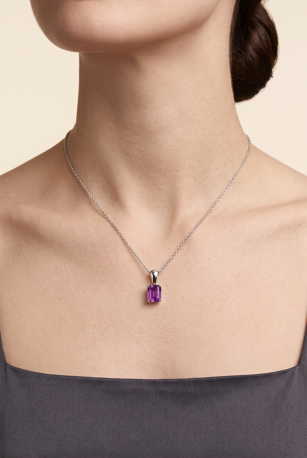 Model wearing the Thamani Purple Sapphire Emerald-Cut Solitaire Pendant Necklace in White Gold