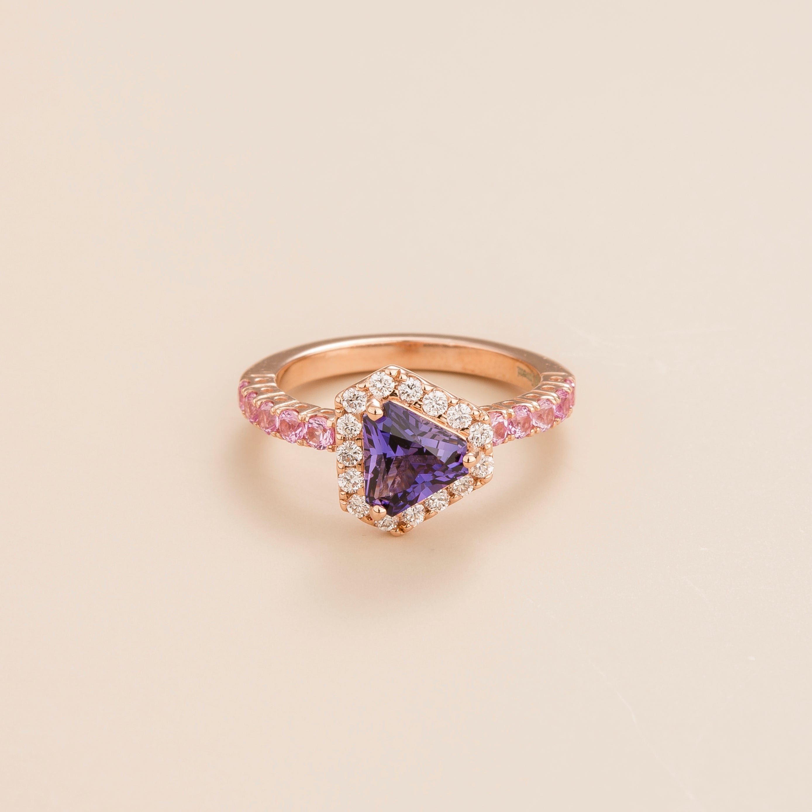 Front view of the Diana Purple Sapphire Triangle Cut, Pink Sapphire Pavé & Diamond Halo Ring in Rose Gold, handcrafted by Juvetti London