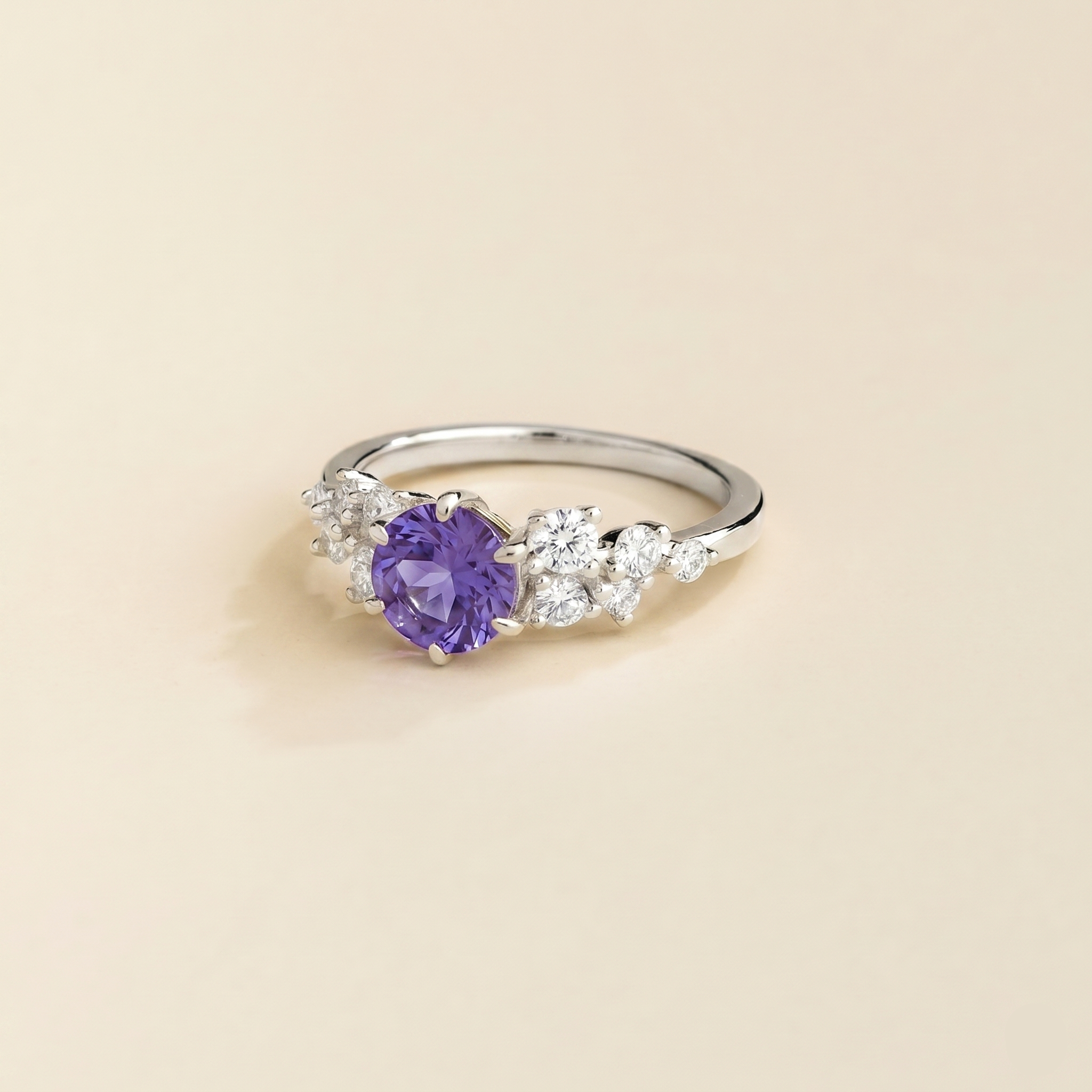 Angled view of the round purple sapphire on the Floret ring in white gold, Juvetti jewellery
