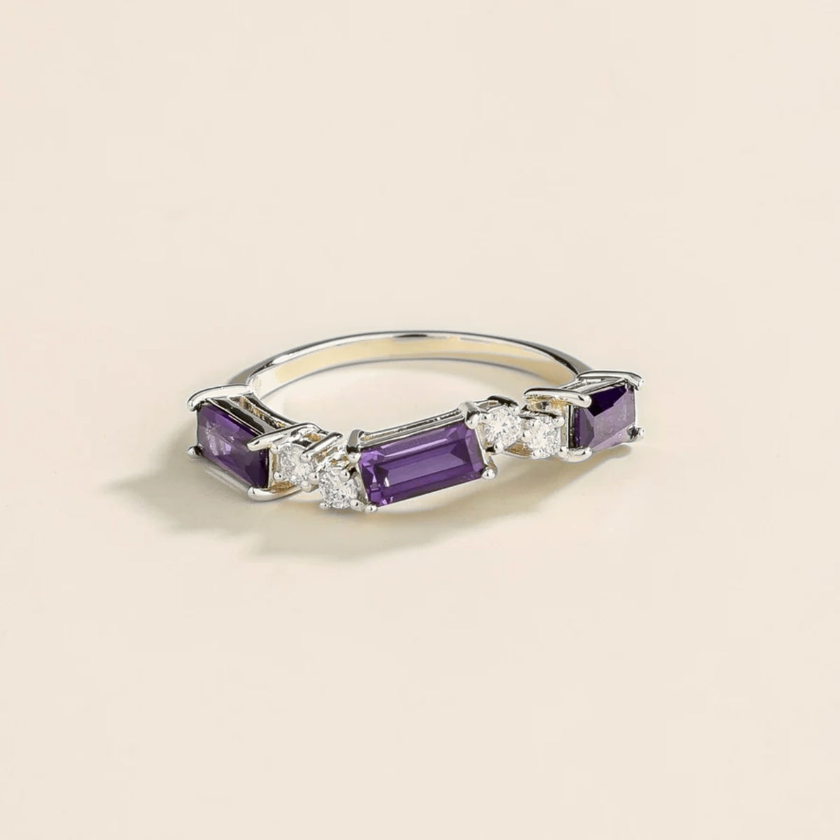 Front view of the Forma Purple Sapphire & Diamond Baguette Cut Three-Stone White Gold Ring, handcrafted by Juvetti London