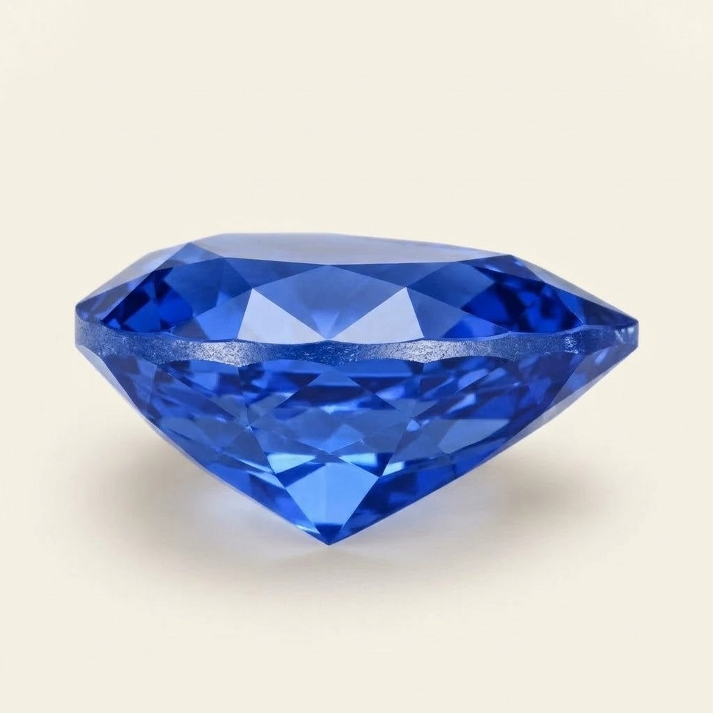 Royal blue lab-grown sapphire, pear cut, side view