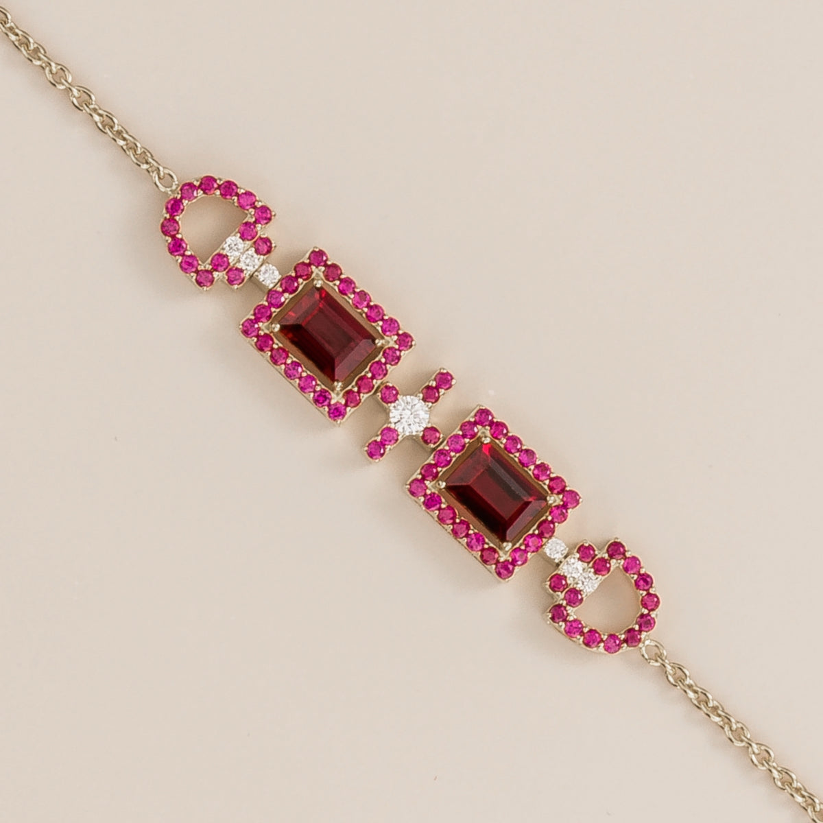 Ciceris ruby Art Deco halo bracelet in white gold, two emerald-cut lab-grown rubies with diamonds, close-up | Juvetti London