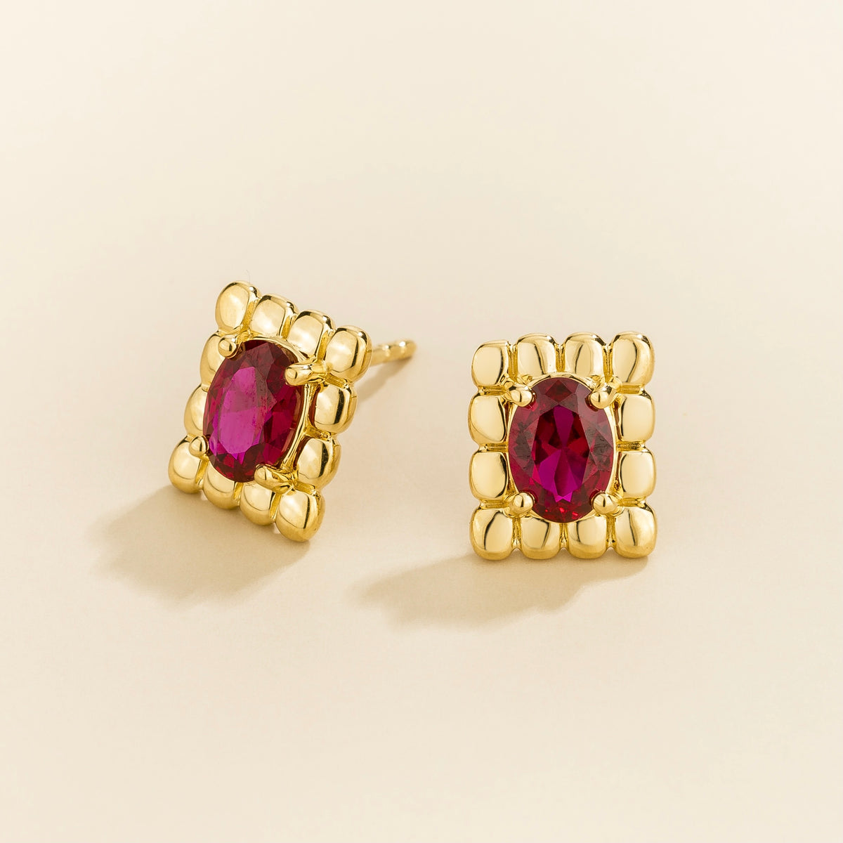 Fondi oval lab-grown ruby sculpted stud earrings in gold – angle view | Juvetti London