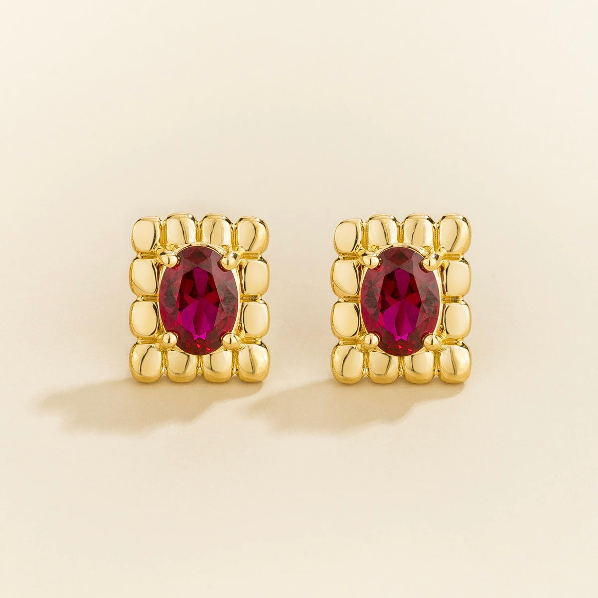 Fondi oval lab-grown ruby sculpted stud earrings in gold – front view | Juvetti London