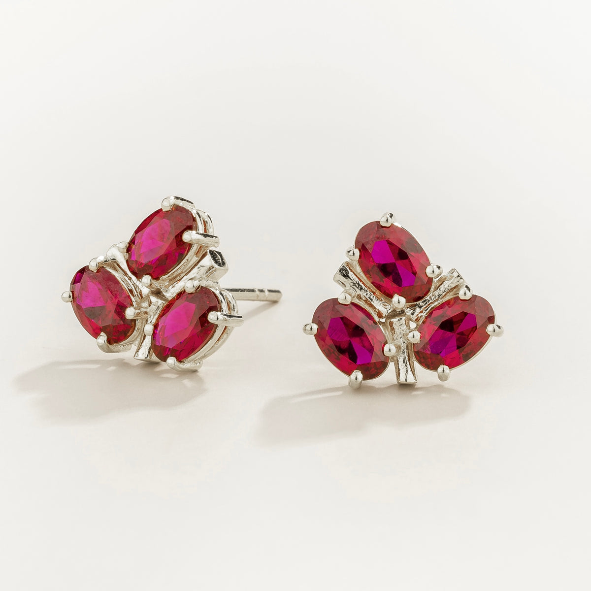 Ligna oval ruby cluster stud earrings in white gold – angle view