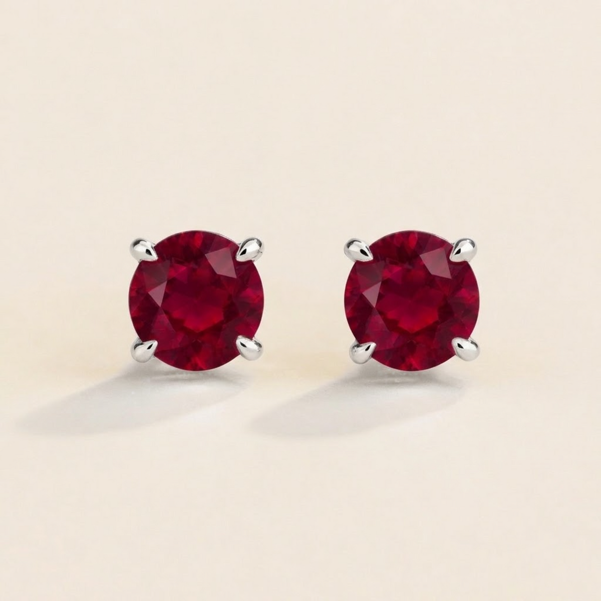 Nina round lab-grown ruby solitaire stud earrings in white gold – front view | Juvetti London