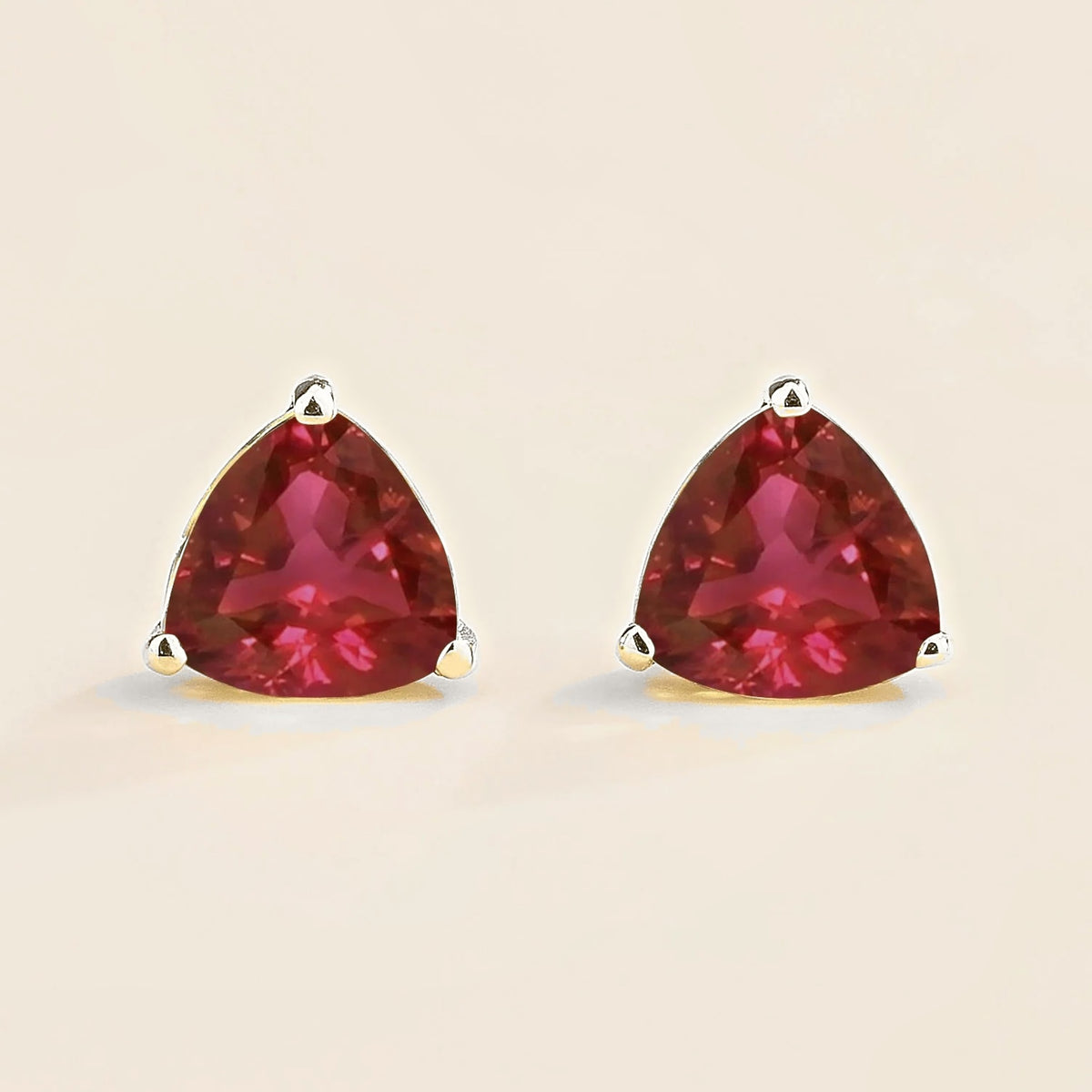 Trillion ruby solitaire stud earrings in white gold