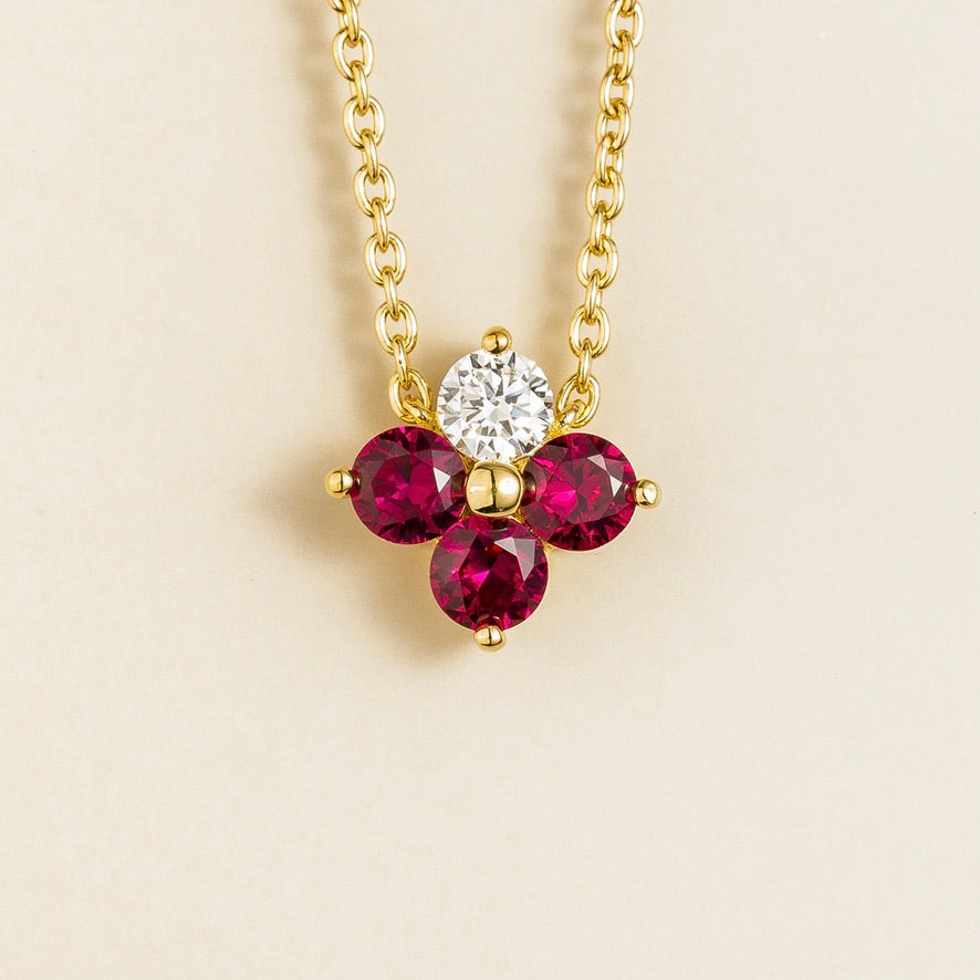 Front view of the Clover Ruby & Diamond Necklace In Gold, handcrafted by Juvetti London