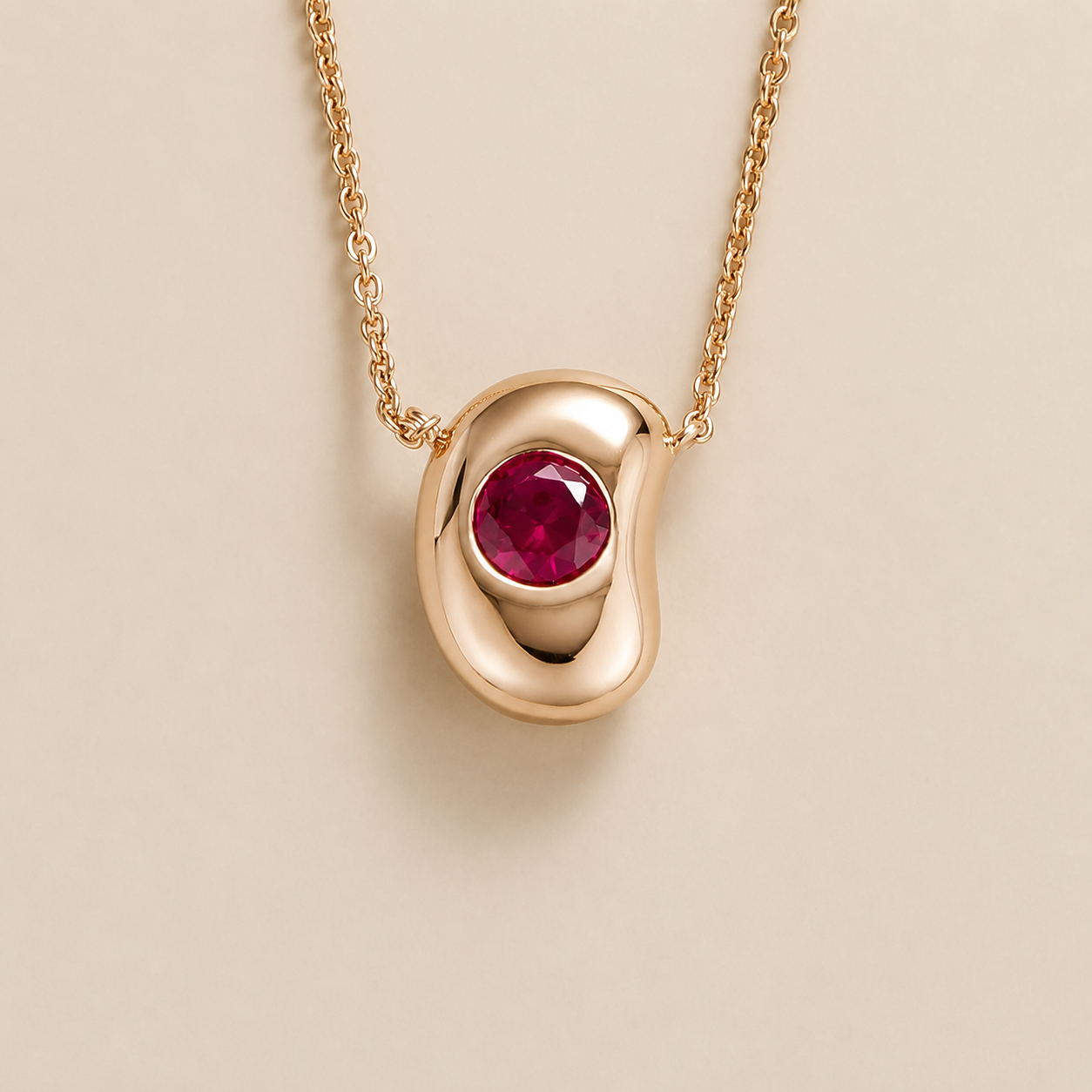 Front view of the Fava Round Ruby Oval Solitaire Pendant Necklace in Rose Gold, handcrafted by Juvetti London