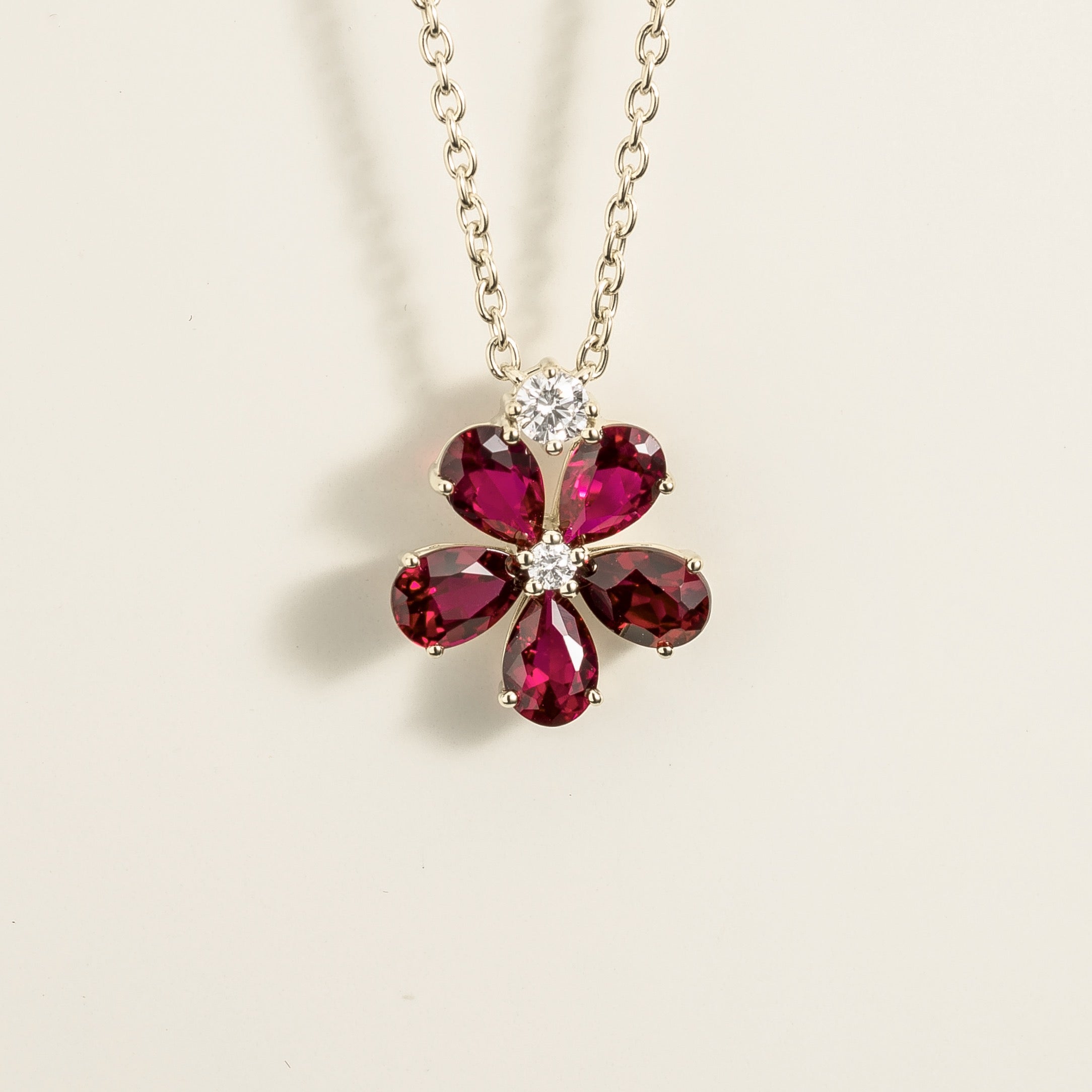 Front view of the Florea Ruby & Diamond Flower Pendant Necklace in White Gold, handcrafted by Juvetti London