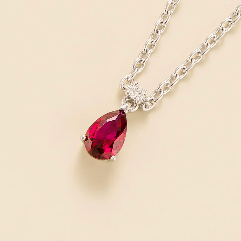 Side view of the pear ruby on the Pisa necklace in white gold, Juvetti jewellery