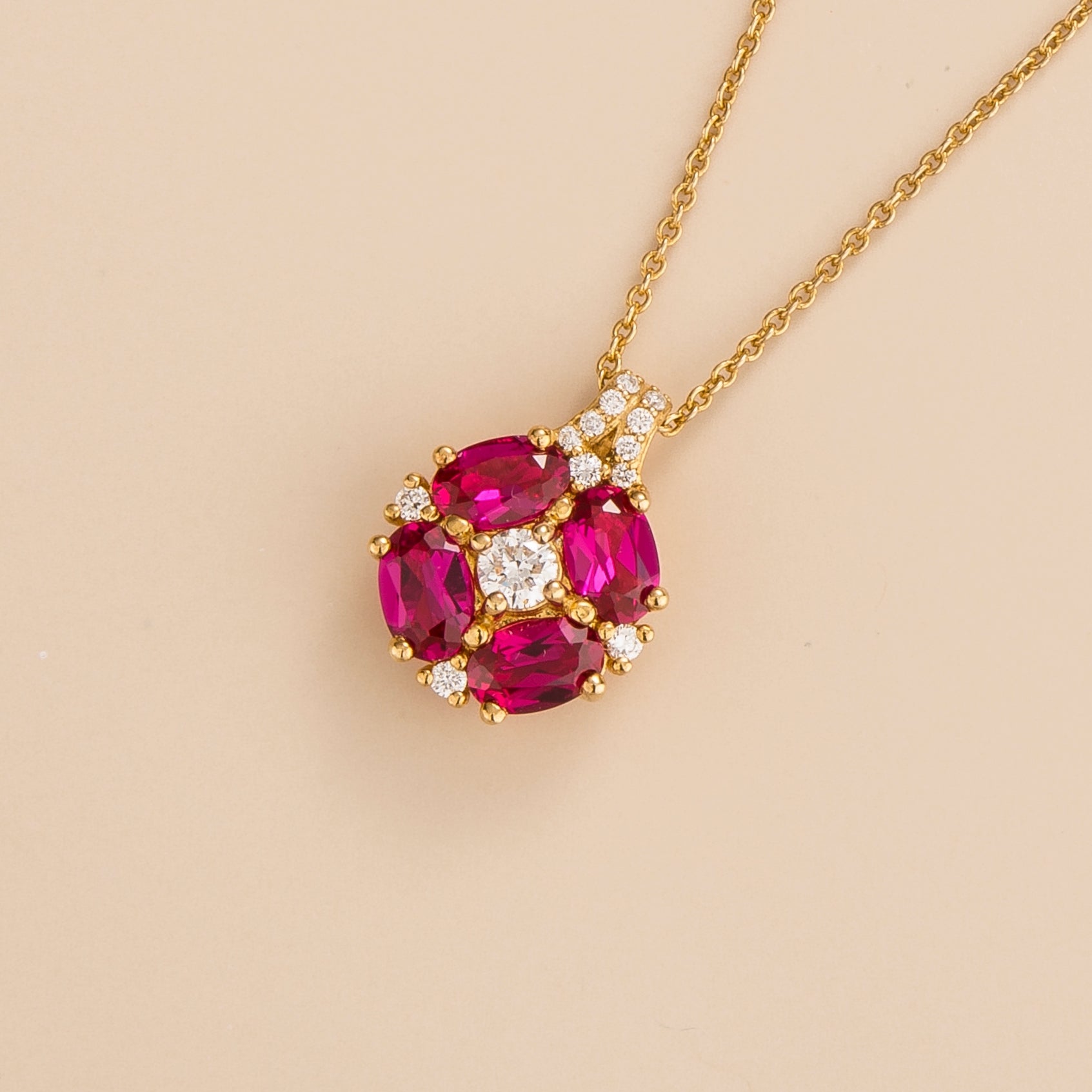 Angled view of the Pristi ruby necklace in gold showing the oval ruby, Juvetti London