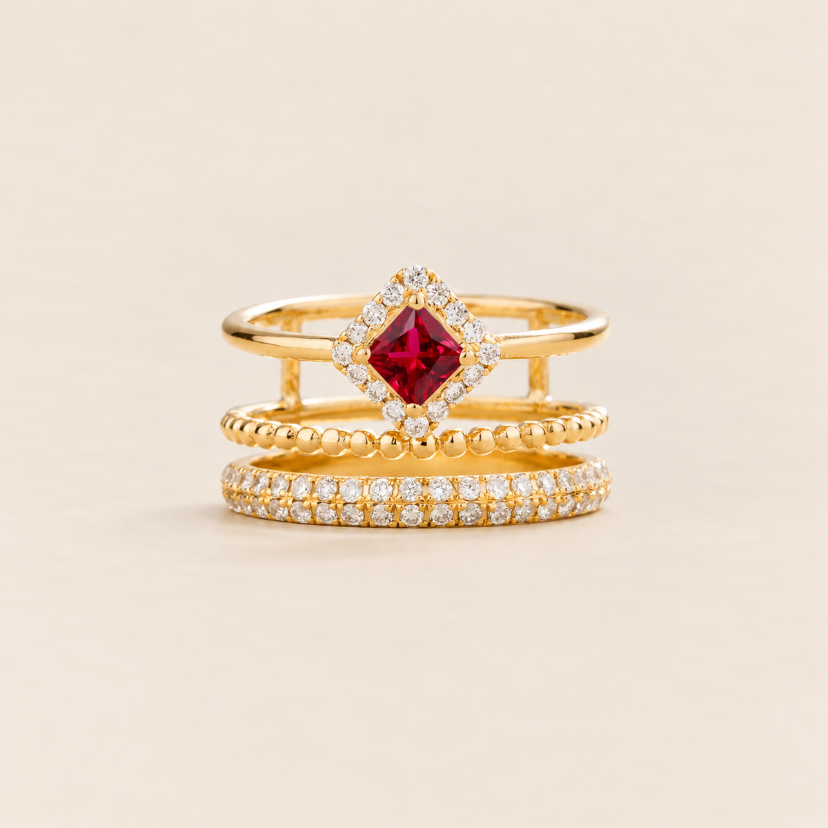 Amici triple-band stacking ring in gold, princess-cut lab-grown ruby in a diamond halo with beaded and pavé bands, front view | Juvetti London