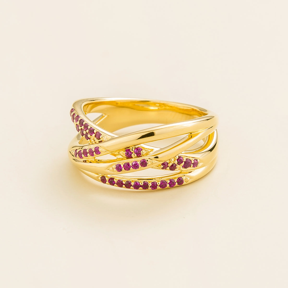Val multi-row crossover band ring with lab-grown rubies in gold – angle view | Juvetti London