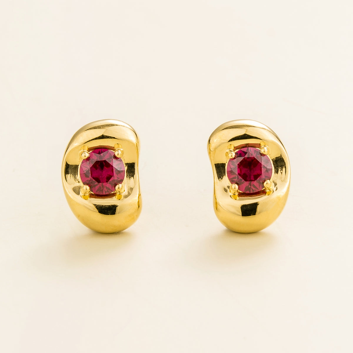 Fava round lab-grown ruby stud earrings in gold, sculpted pebble setting, front view | Juvetti London