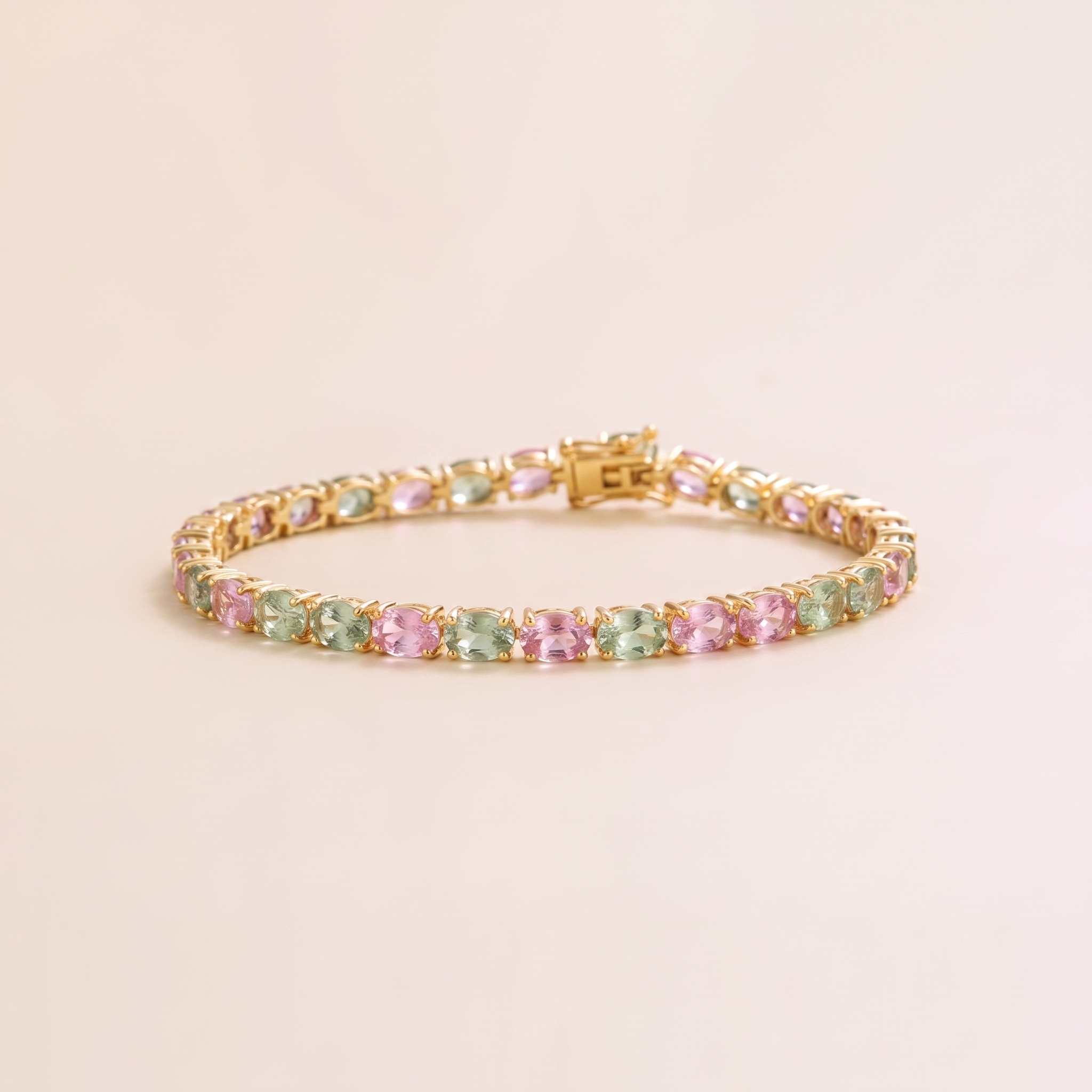 Oval lab-grown pastel pink and green sapphire tennis bracelet in gold | Juvetti London.
