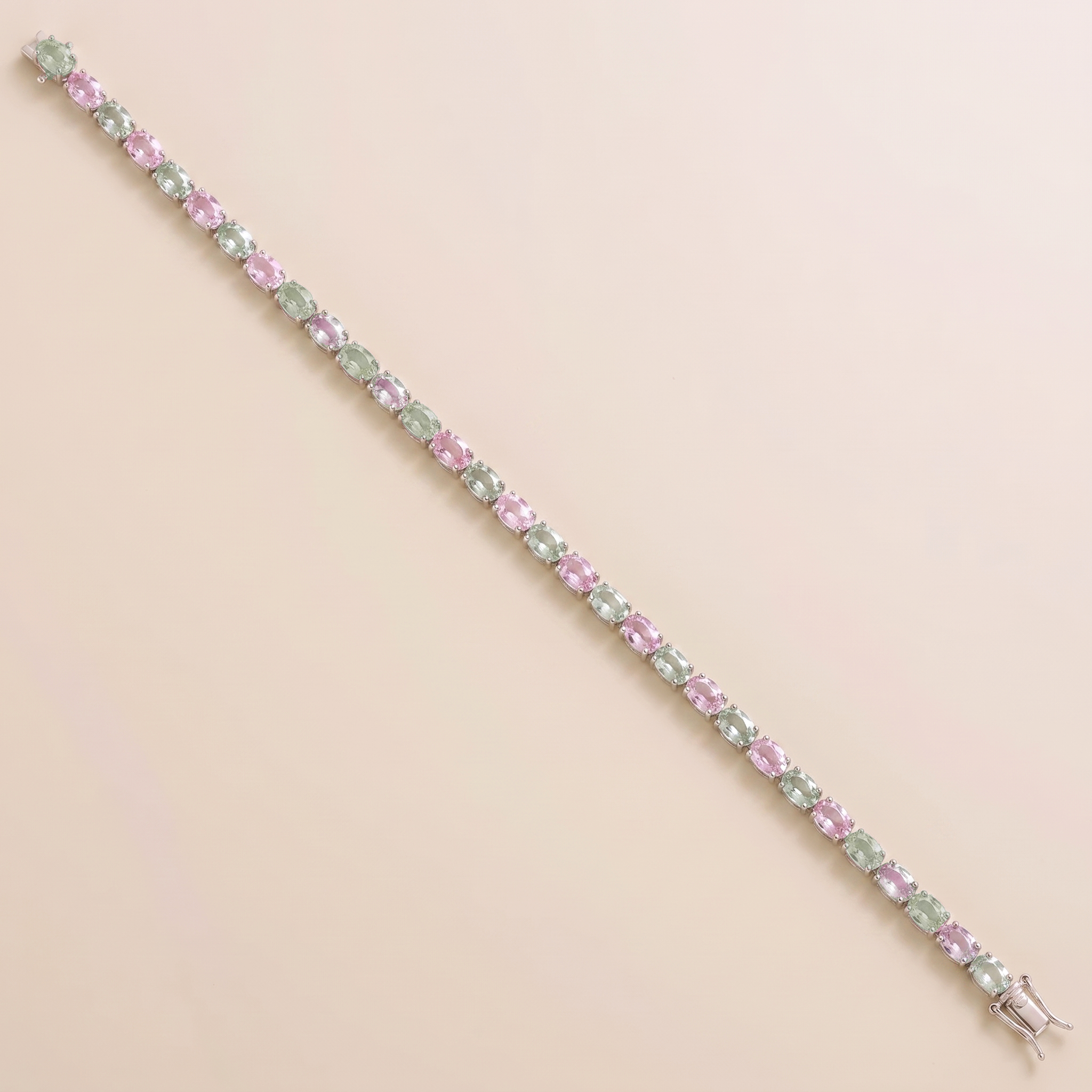 Oval lab-grown pastel pink and green sapphire tennis bracelet in white gold | Juvetti London.