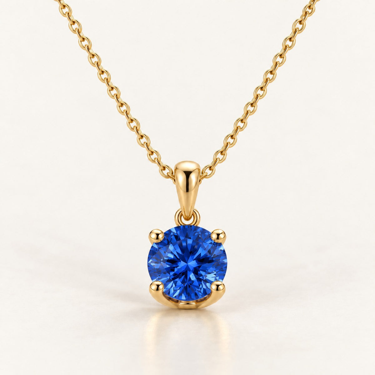 Solitaire pendant setting shown with a blue sapphire