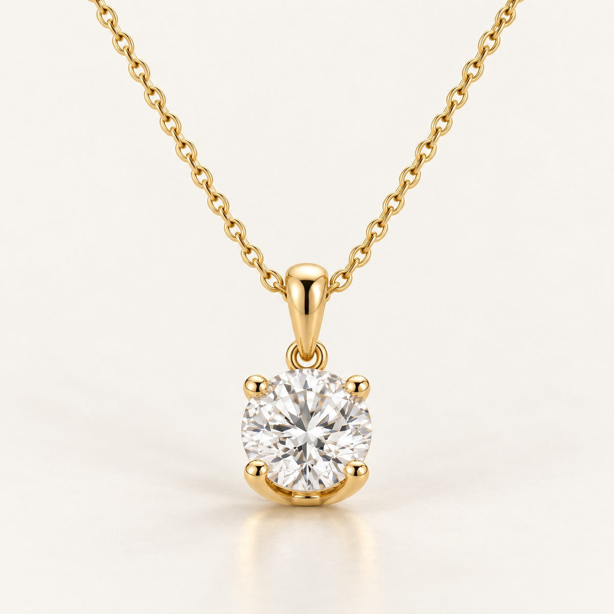 Solitaire pendant setting in yellow gold: four-claw head and plain bail on a fine chain, shown with a 1 ct round diamond