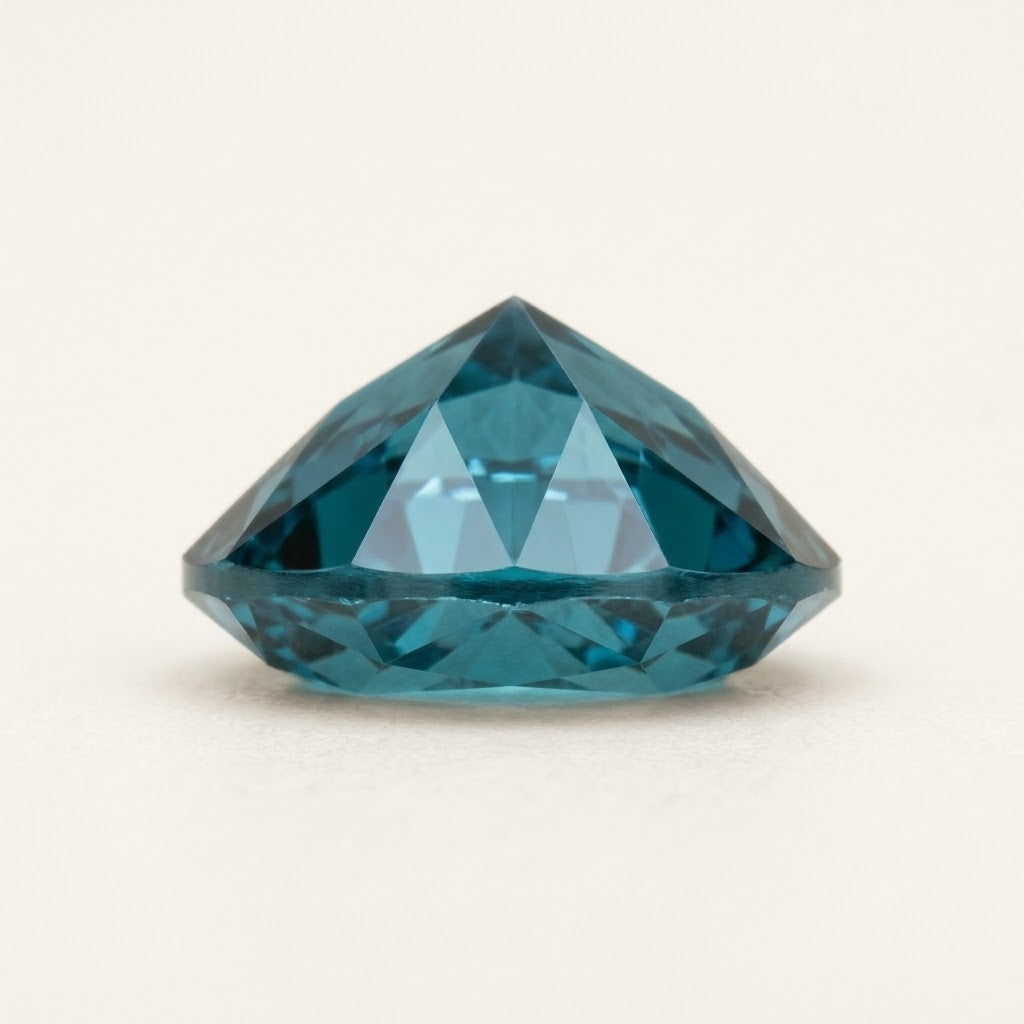 Teal lab-grown sapphire, heart cut, side view