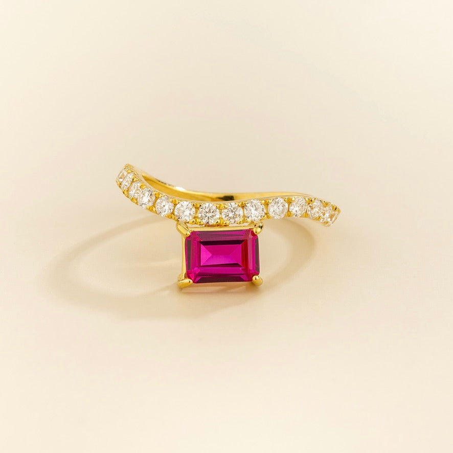 Luno vivid hot pink sapphire emerald-cut ring with diamond pavé in gold, lab-grown sapphire set east-west, side view | Juvetti London