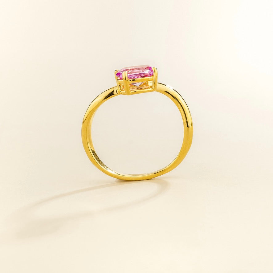 Luno vivid pink sapphire oval ring in gold, lab-grown sapphire set east-west, profile view | Juvetti London