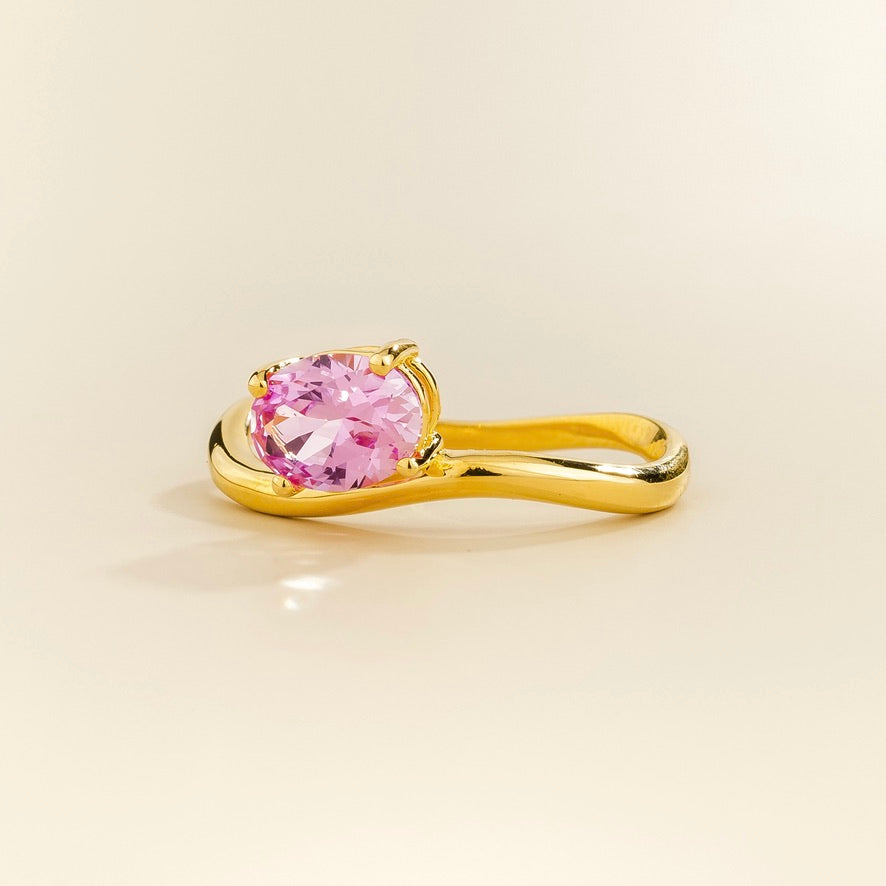 Luno vivid pink sapphire oval ring in gold, lab-grown sapphire set east-west, top view | Juvetti London