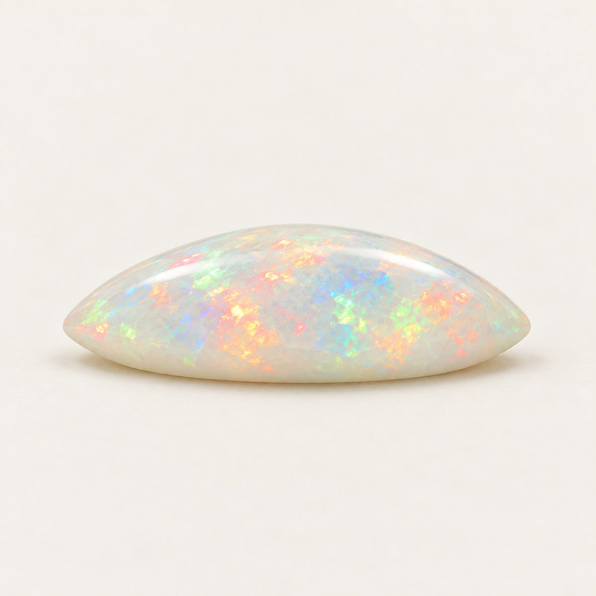 White lab-grown opal, marquise cabochon, side view