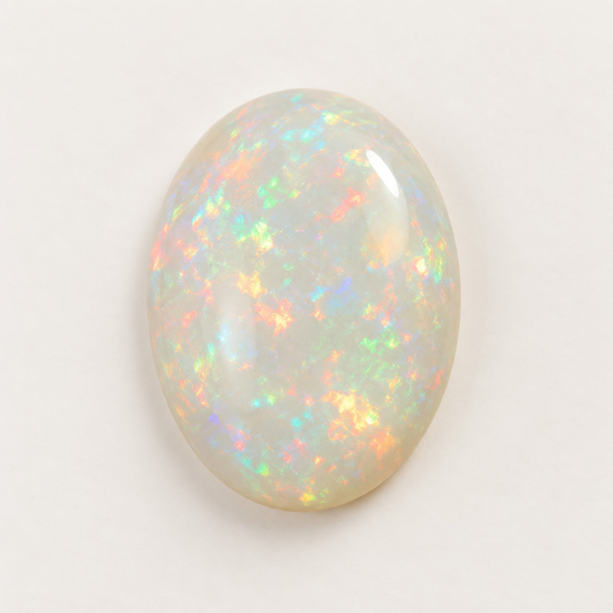 White lab-grown opal, oval cabochon