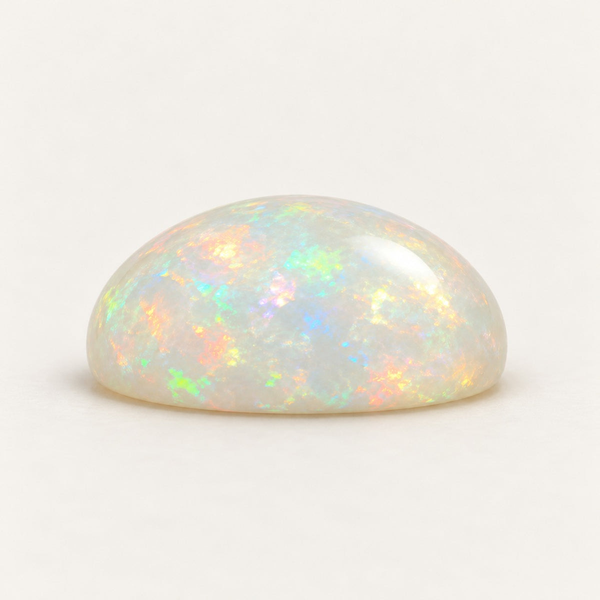 White lab-grown opal, round cabochon, side view