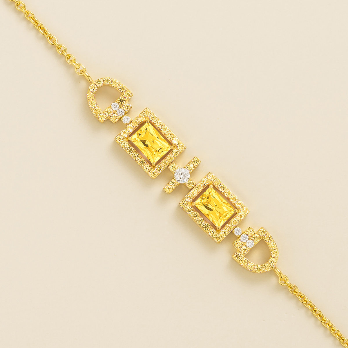 Ciceris yellow sapphire Art Deco halo bracelet in gold, two emerald-cut lab-grown sapphires with diamonds, close-up | Juvetti London