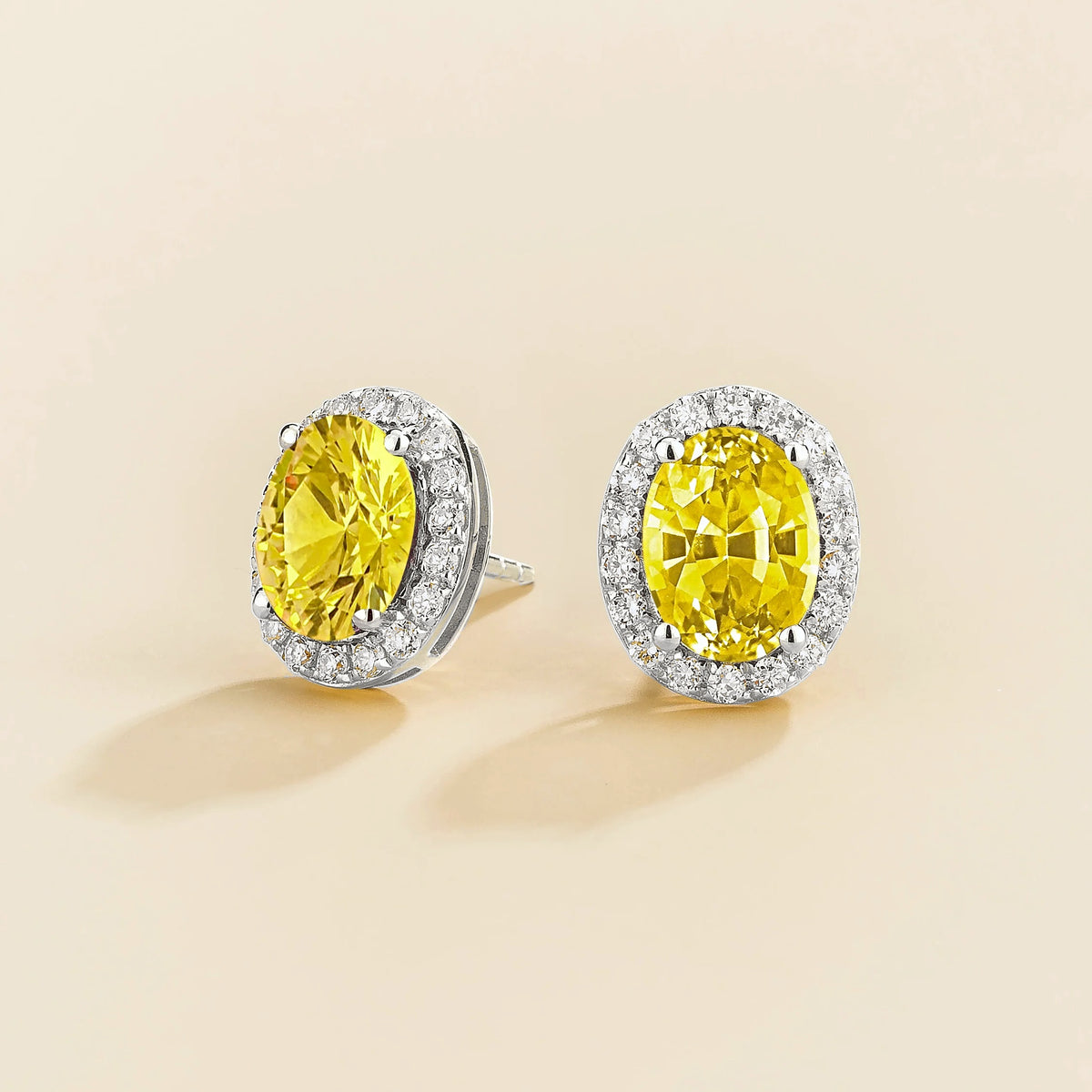 Lab-grown yellow sapphire and diamond oval halo stud earrings in white gold – side view | Mina by Juvetti
